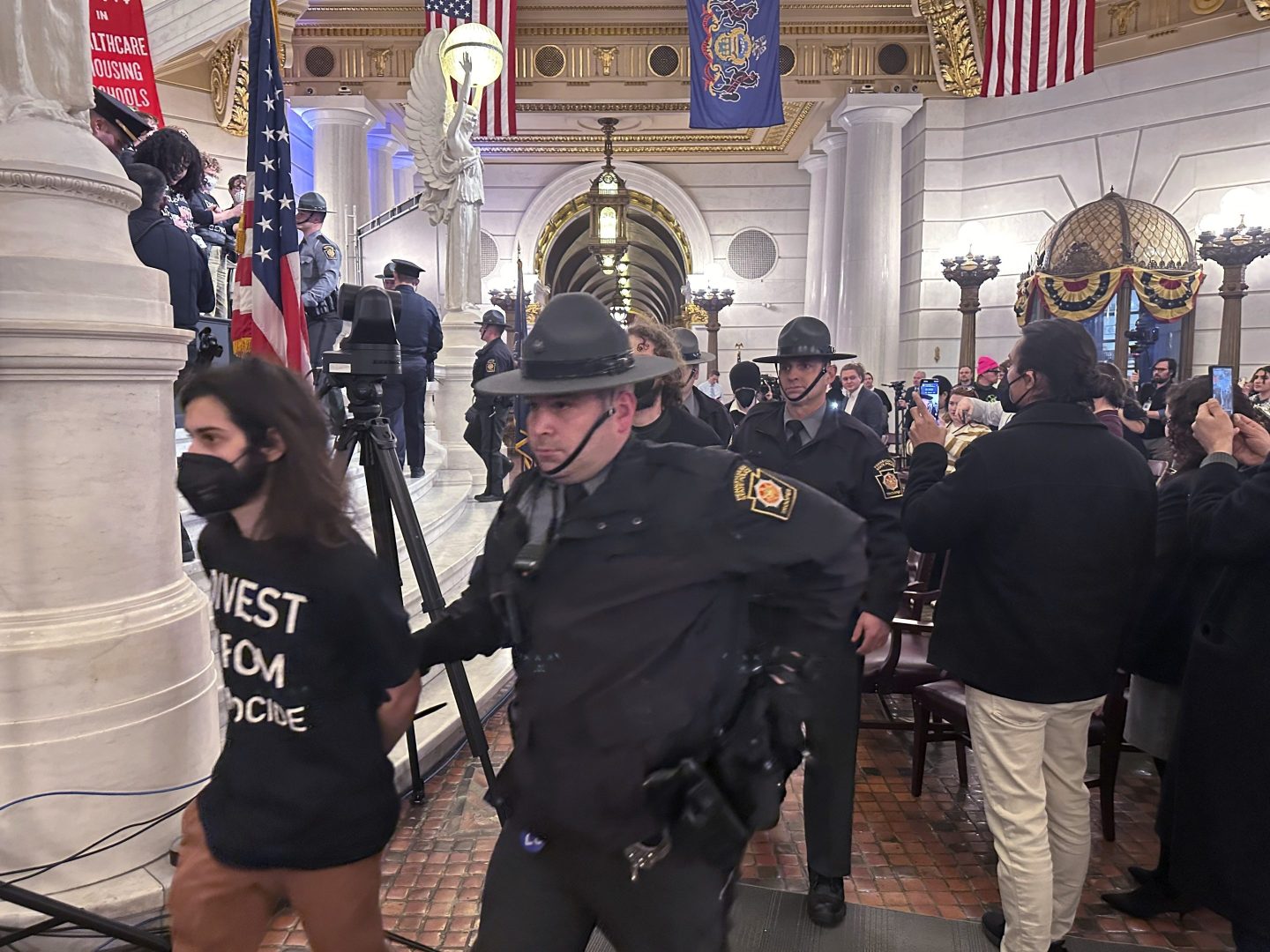 Police arrest some of the 126 people taken into custody on Feb. 5, 2024, in the Rotunda of the State Capitol in Harrisburg, Pa. 