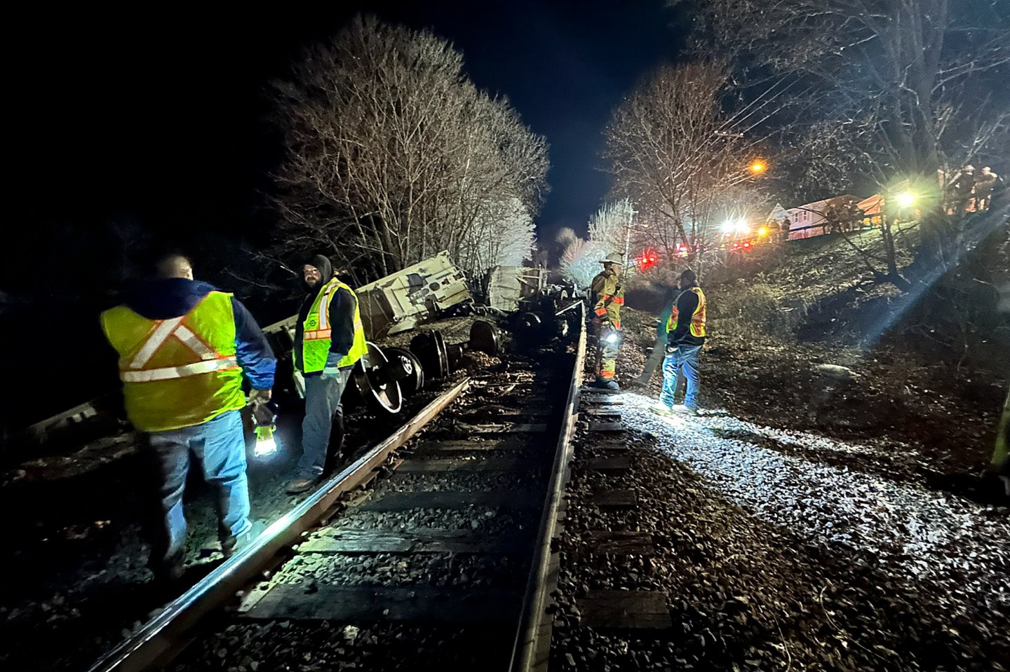 Train crews and first responders walk the site of a train derailment, on Feb. 7, 2024, in Valley Falls, N.Y.