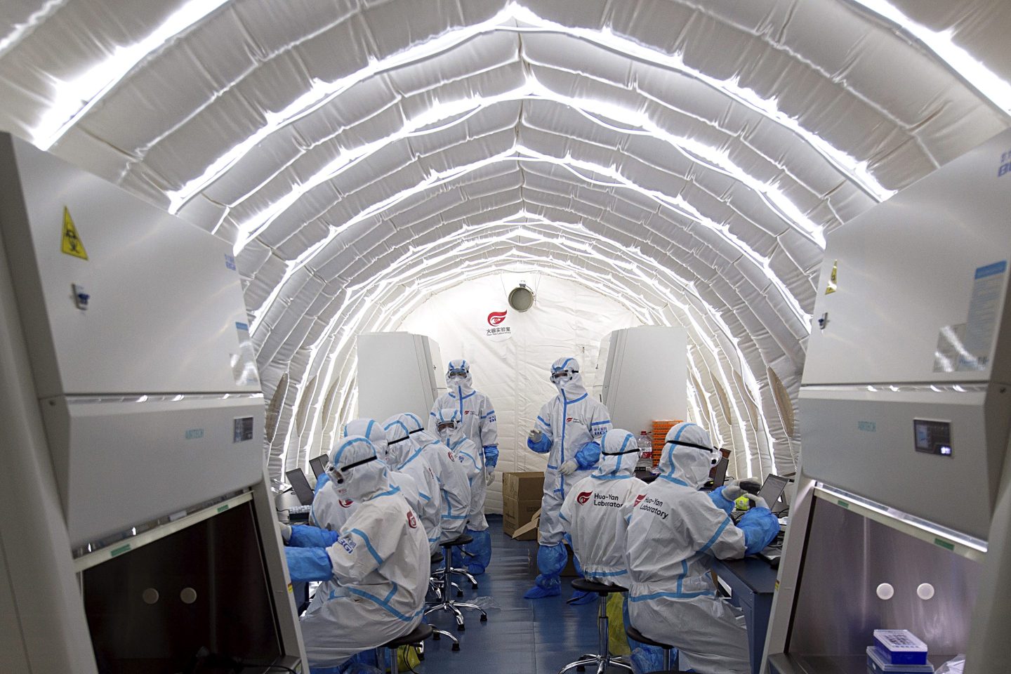 Staff members work in an inflatable COVID-19 testing lab provided by Chinese biotech company BGI Genomics, a subsidiary of BGI Group, in Beijing, June 23, 2020.