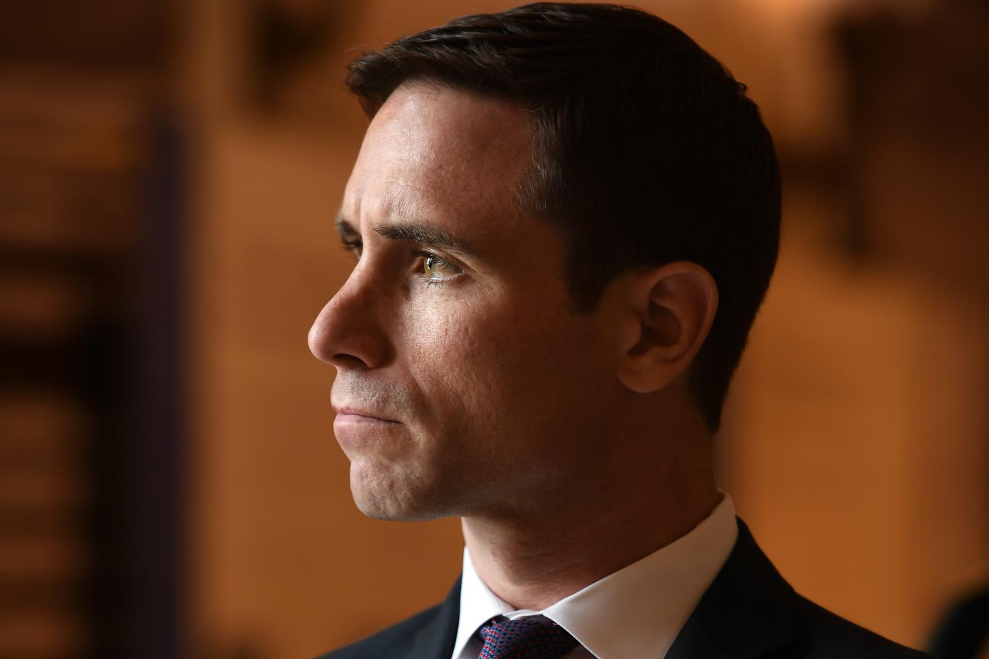 Portrait of Brian Kinsella in brown background.