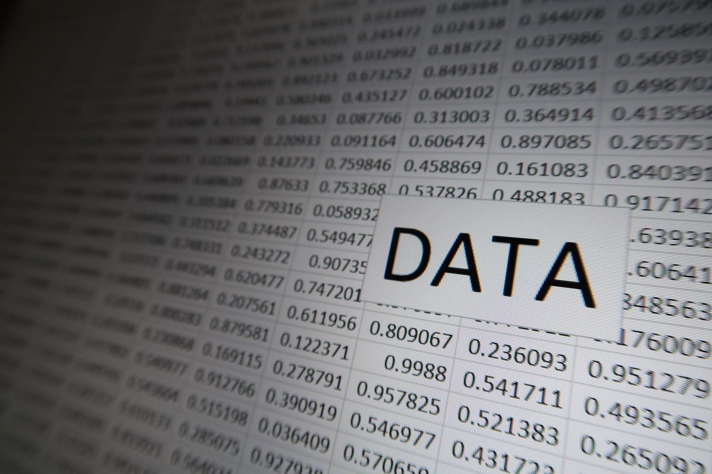 The word "DATA" appears against a grid of random numbers on a digital display
