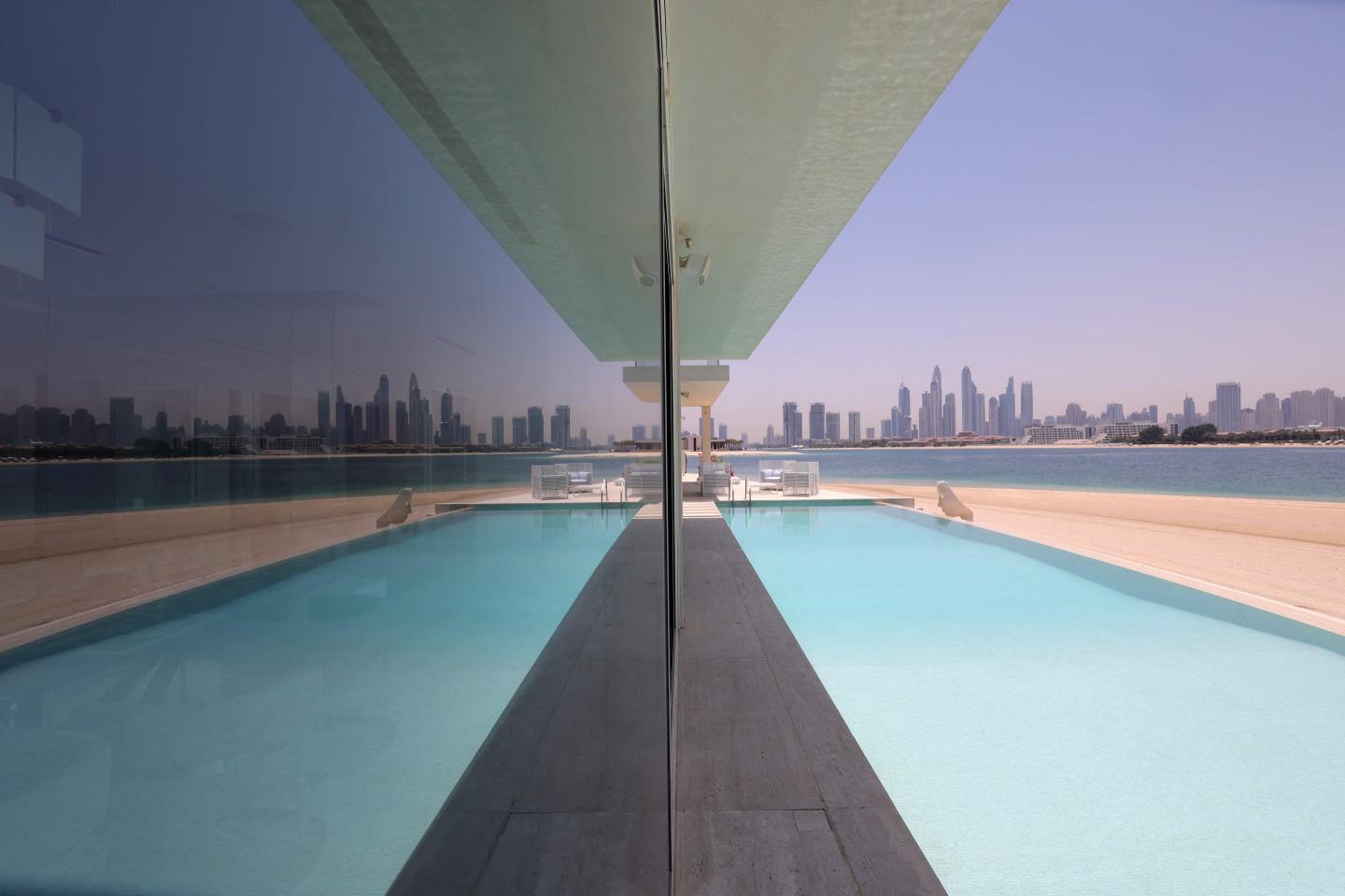 This picture shows the swimming pool of a luxury villa for sale on one of the Palm Jumeirah man-made island