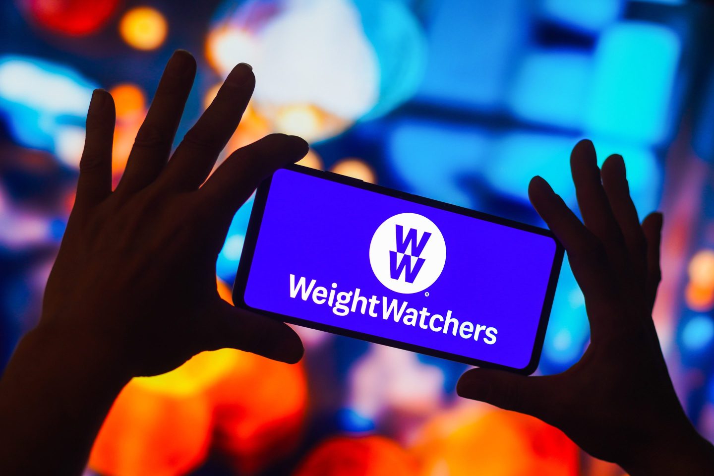 In this photo illustration, the Weight Watchers logo is displayed on a smartphone screen.