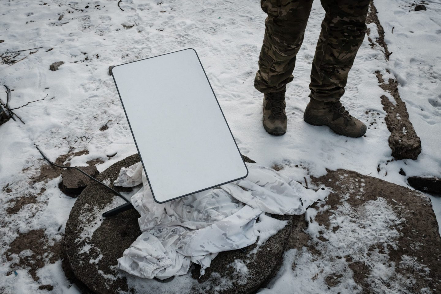 A Ukrainian serviceman stands next to an antenna of the Starlink satellite-based broadband system in Bakhmut last year.