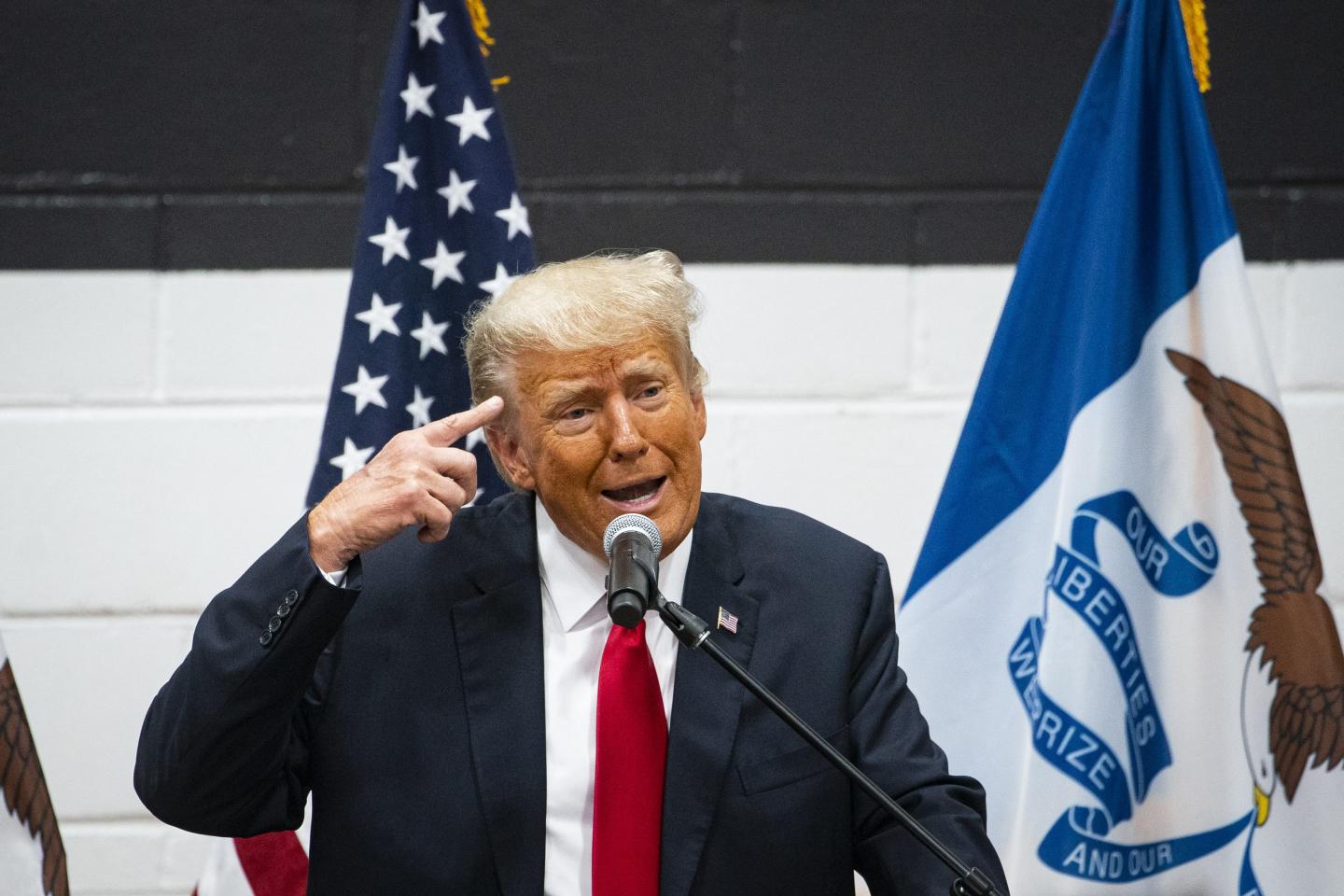 President Donald Trump at the podium giving a campaign speech.
