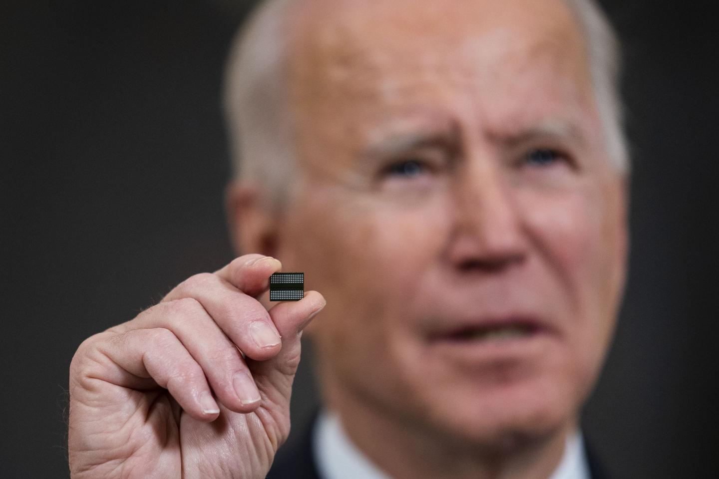 Joe Biden holding a computer chip.