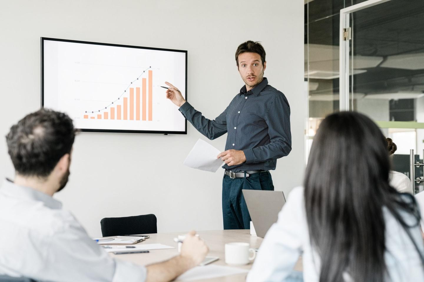 Businessman giving a presentation with a graph.