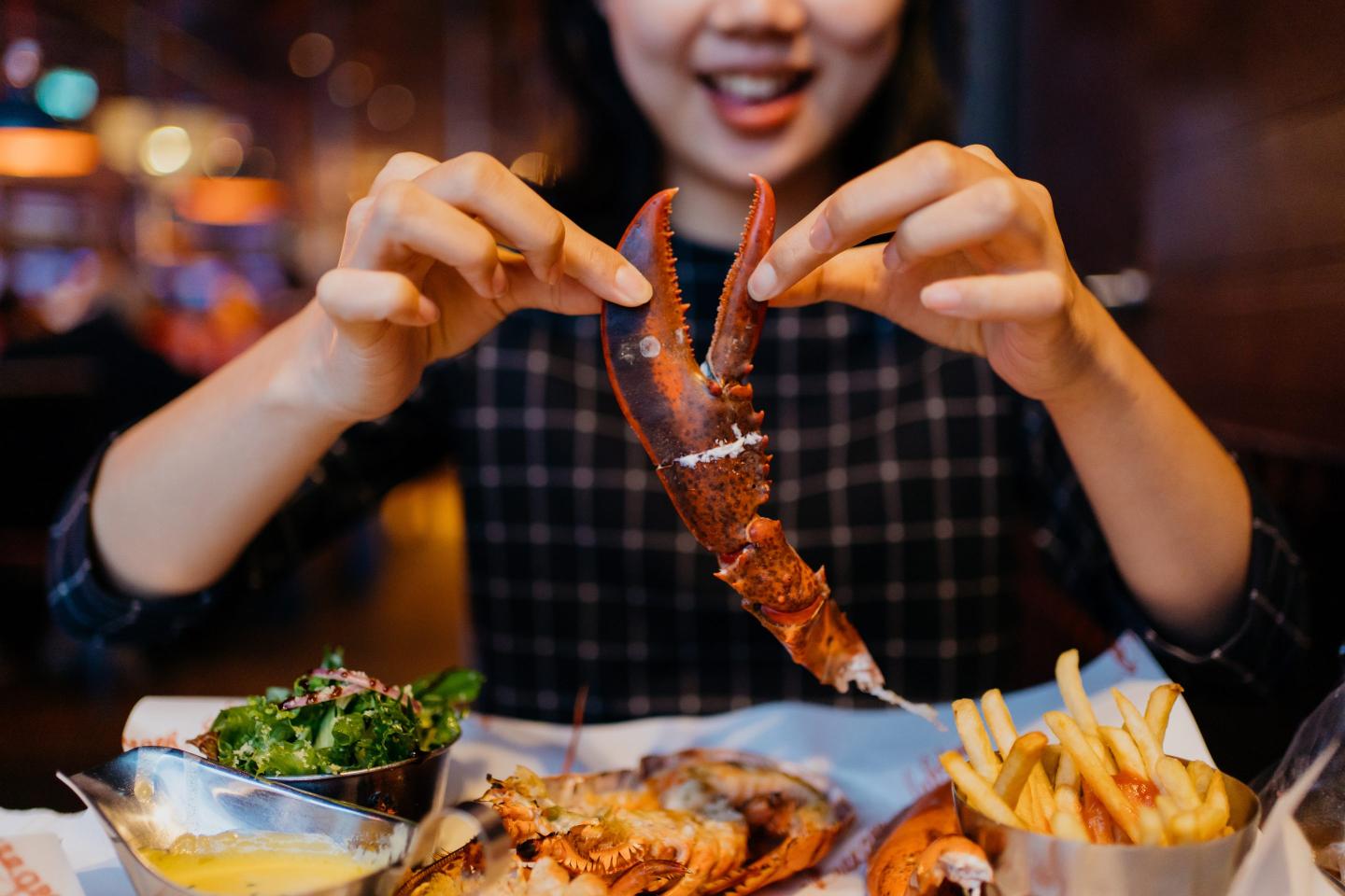 Woman eating lobster