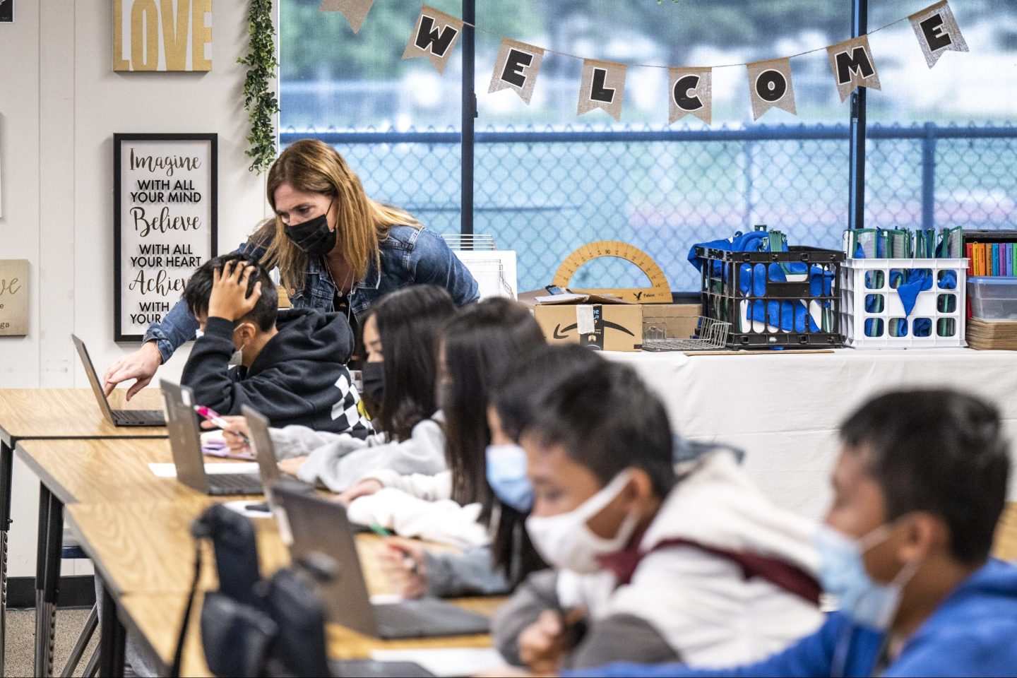 Lori Manz, who is normally a curriculum specialist in the teaching and learning department at the Ocean View School District, substitute-teaches in a seventh-grade math class at Vista View Middle School in Huntington Beach, Calif., on Jan. 20, 2022.