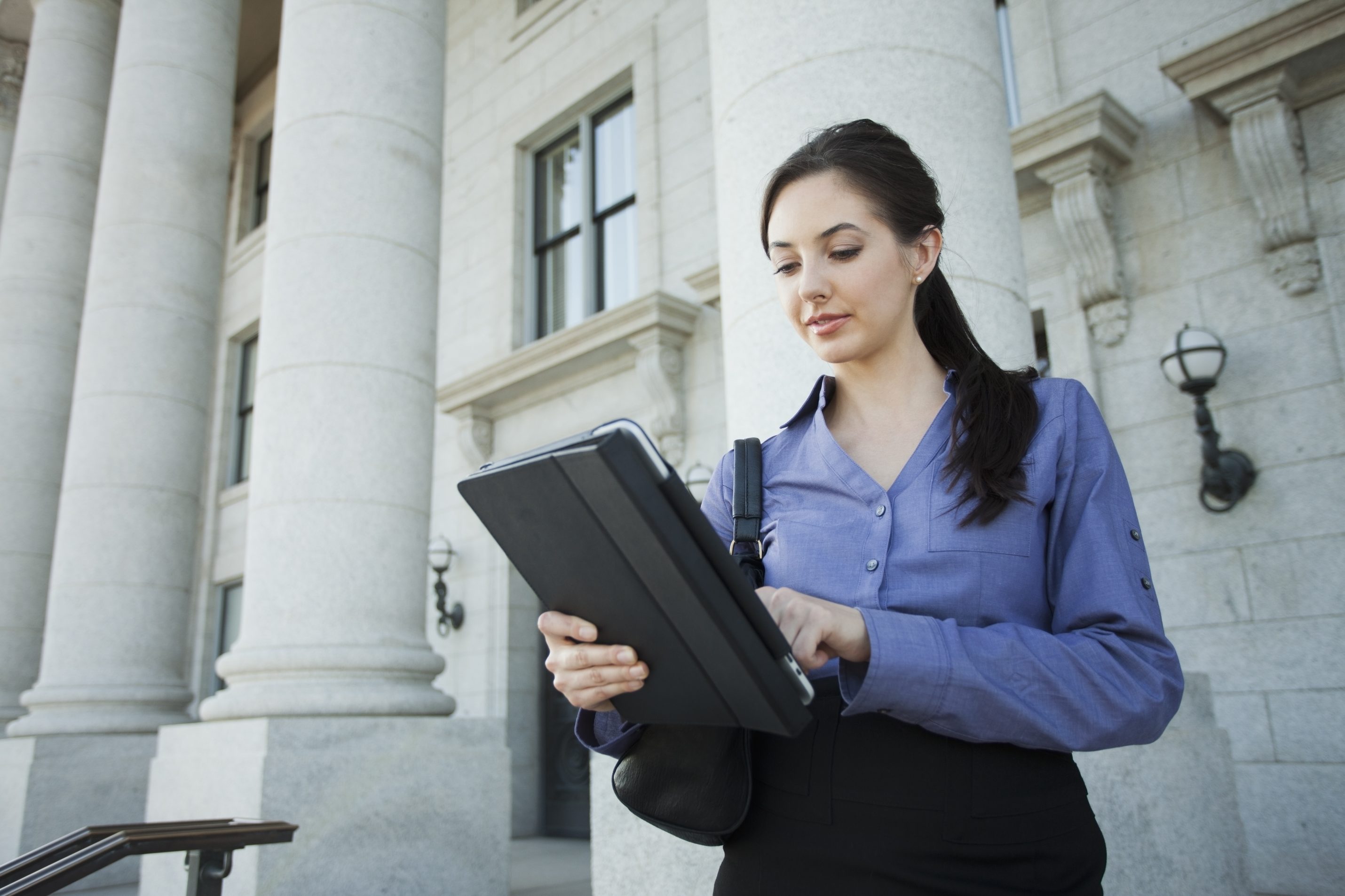 Young businesswoman using a digital tablet outdoors