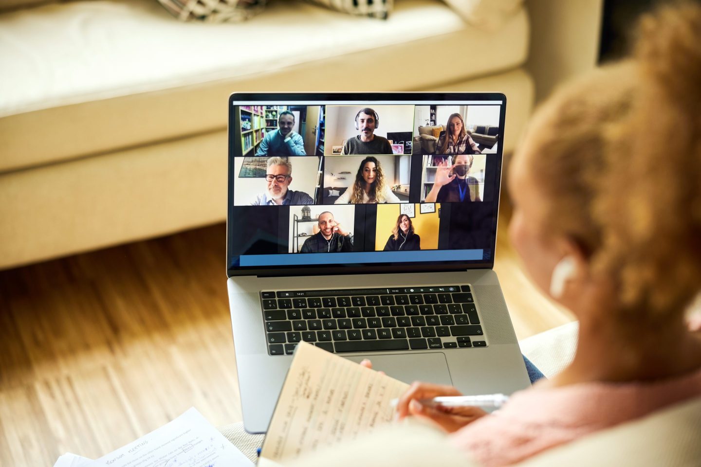 A woman attends a virtual work meeting on her laptop.