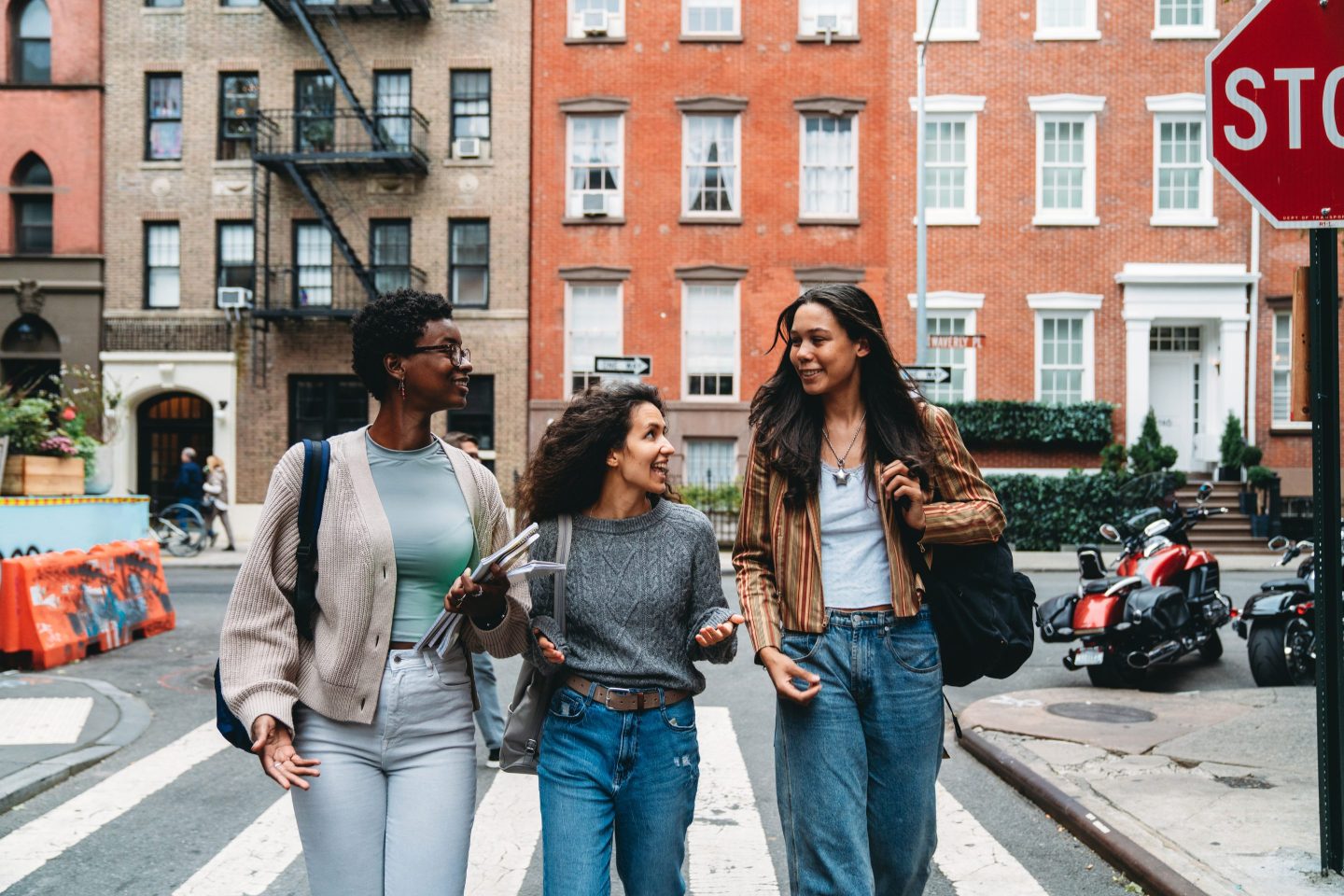 Three Gen Z women walking through New York City