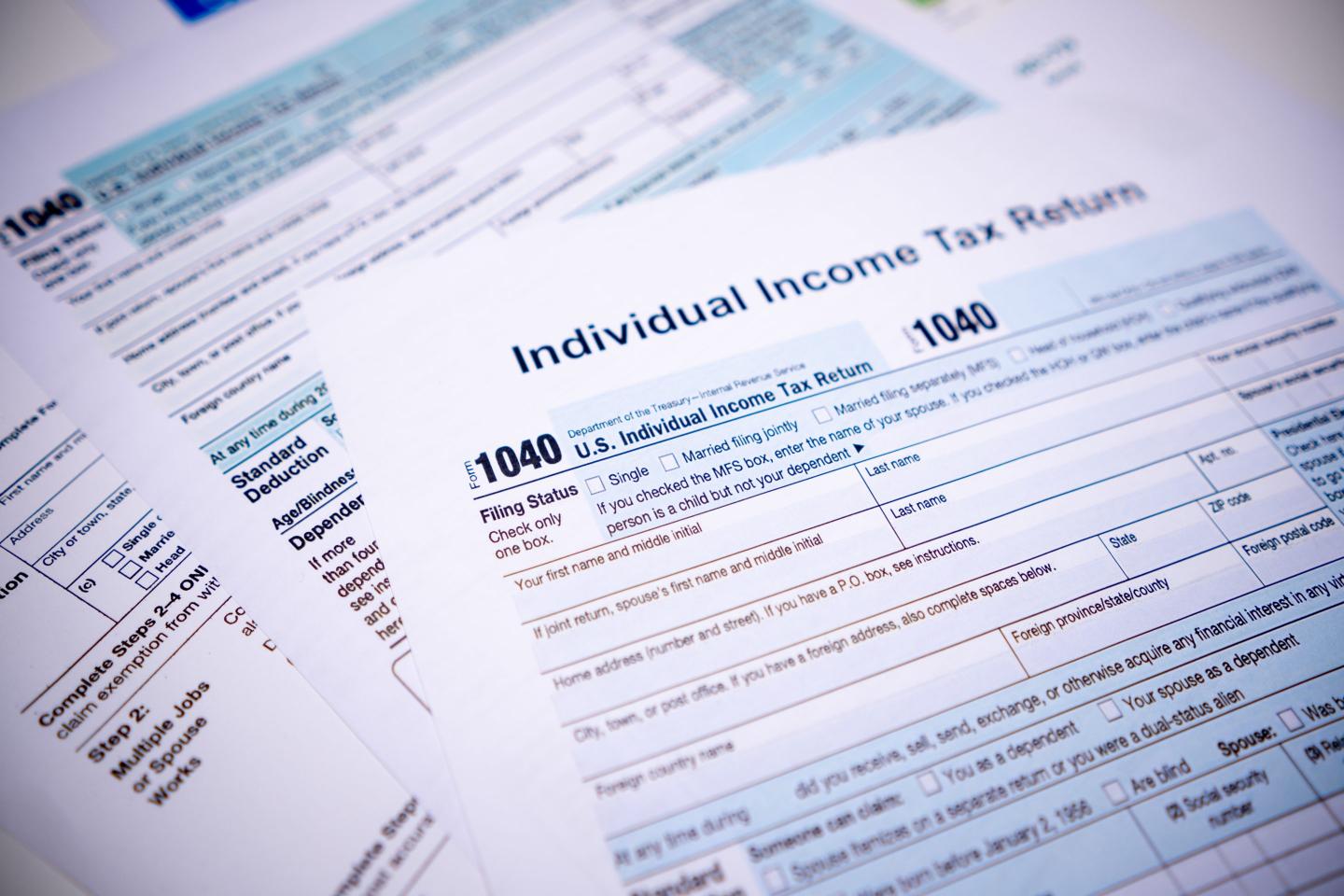Photo of paper tax forms spread out on a table