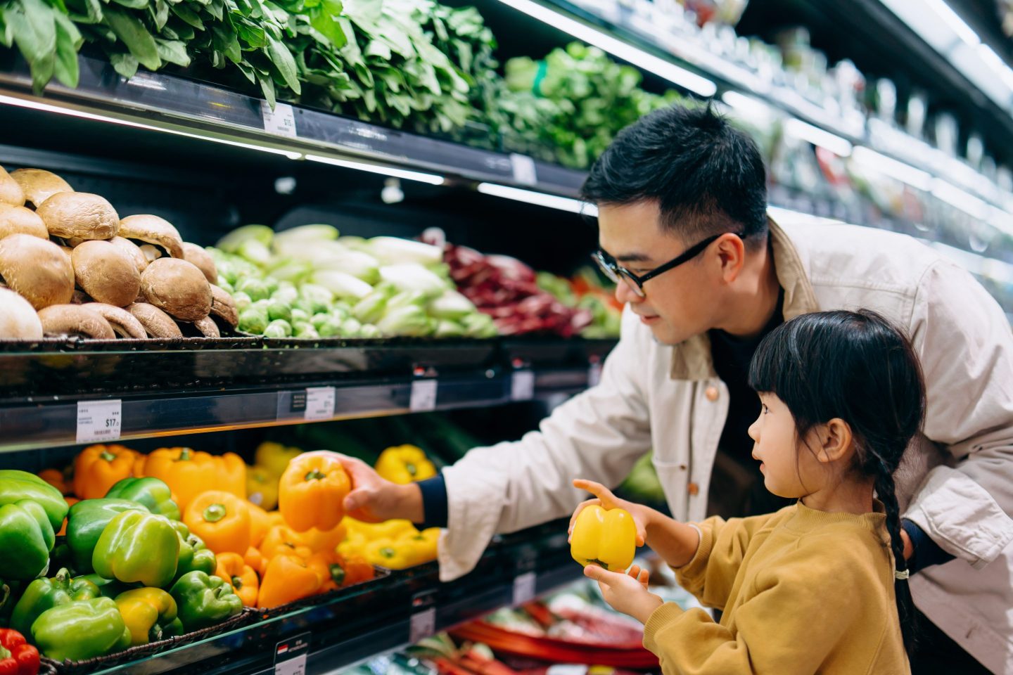 Young father and little daughter grocery shopping