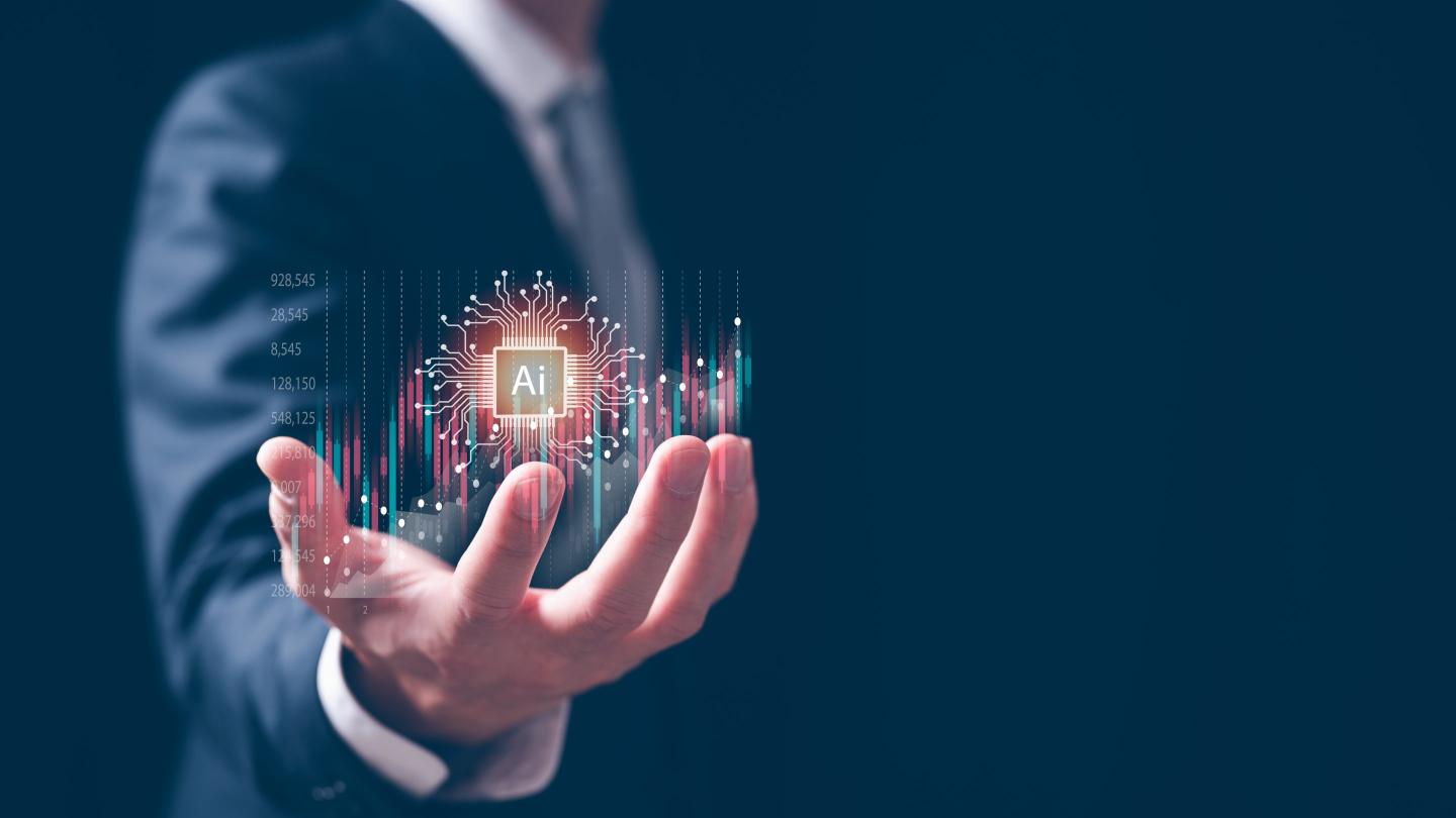 a hand holding an Ai graphic