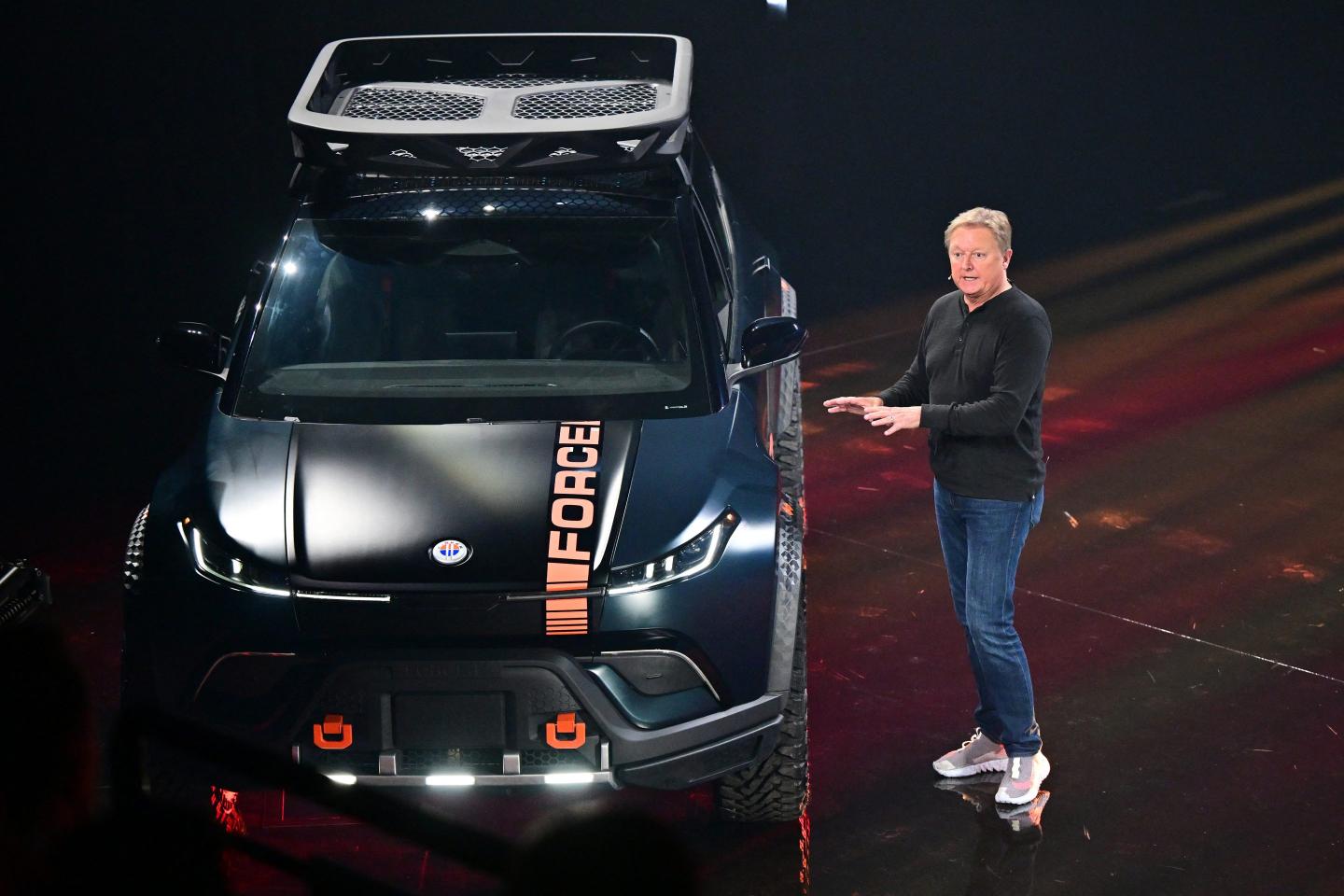 fisker ceo henrik fisker standing beside a black car