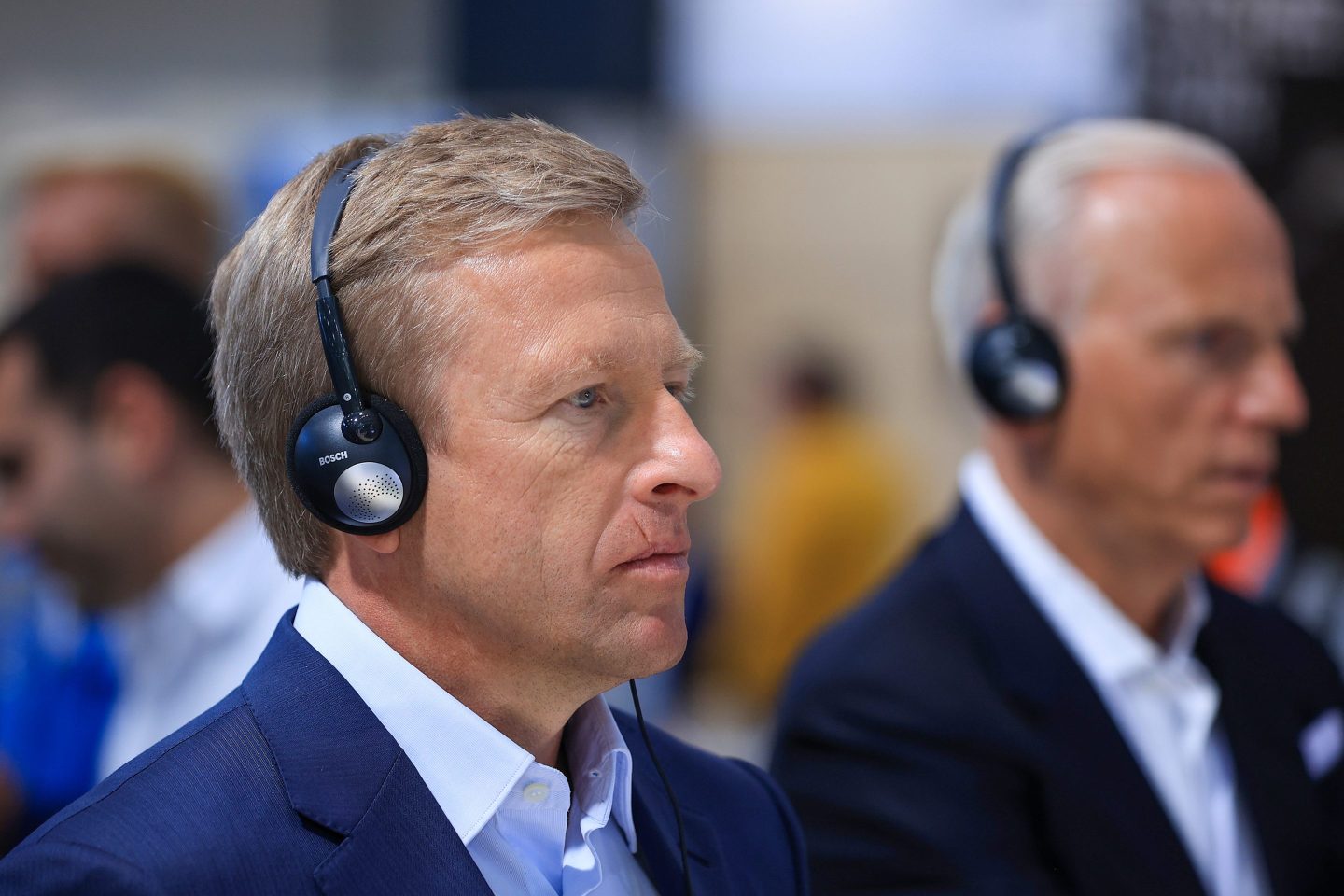 BMW CEO Oliver Zipse with headphones on.