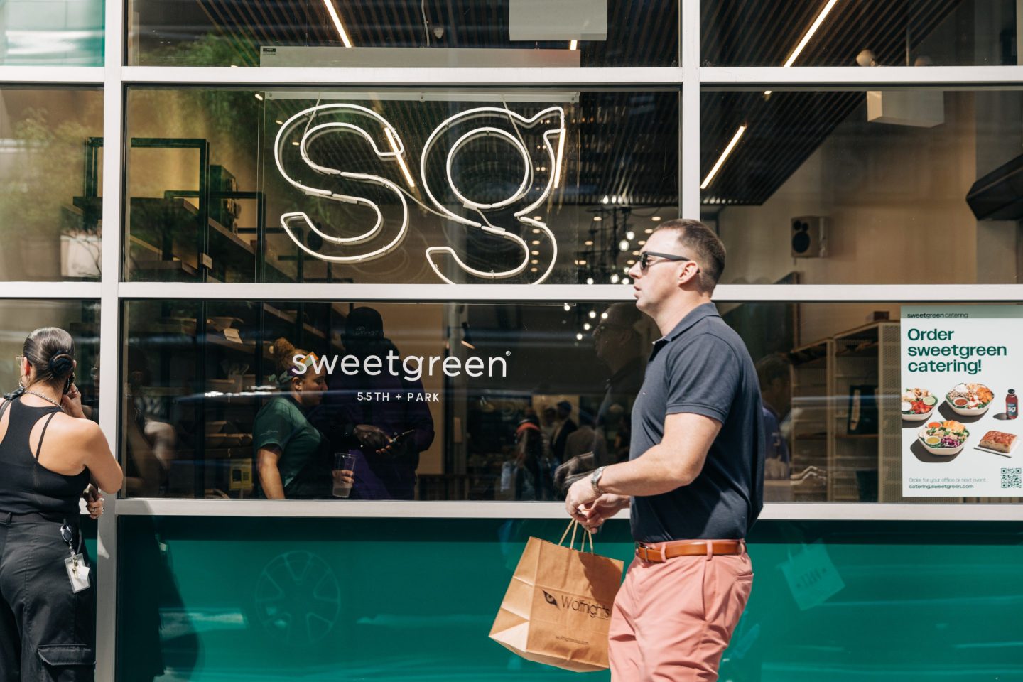 A man walking in front of Sweetgreen