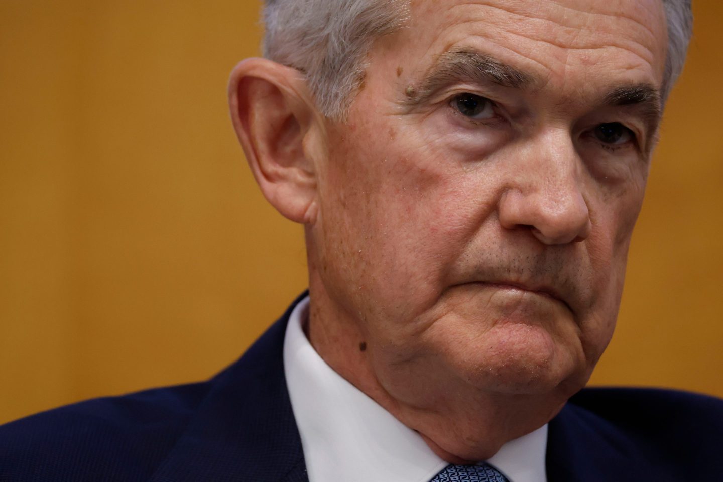 Close up on Jerome Powell, Federal reserve president. He's wearing a suit and has a serious expression.