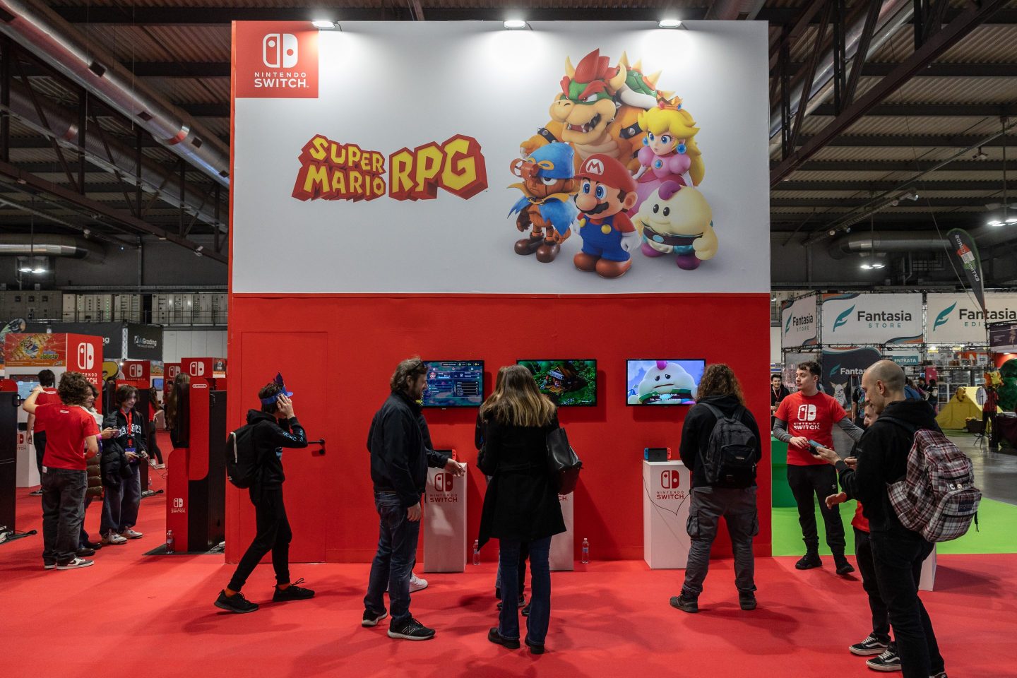 Fairgoers play video games at the Nintendo Switch stand on Nov. 24, 2023 at the Milan Games Week.