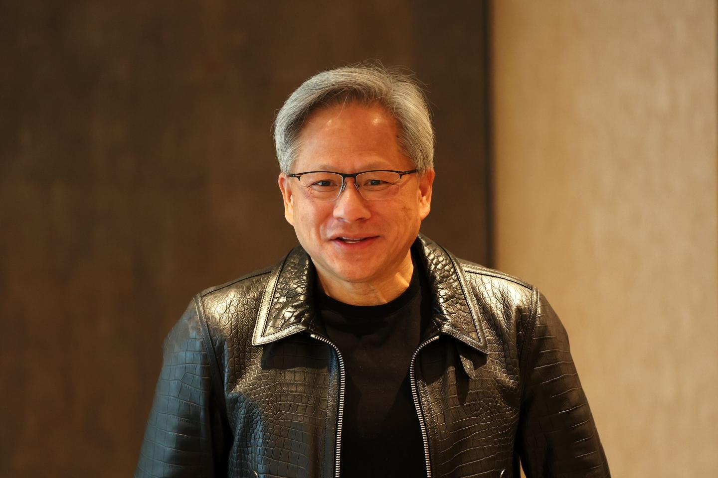 Jensen Huang, co-founder and chief executive officer of Nvidia Corp., speaks at a roundtable in Singapore, on Wednesday, Dec. 6, 2023. Huawei Technologies Co. is among a field of "very formidable" competitors to Nvidia in the race to produce the best AI chips, according to Huang. Photographer: Lionel Ng/Bloomberg via Getty Images
