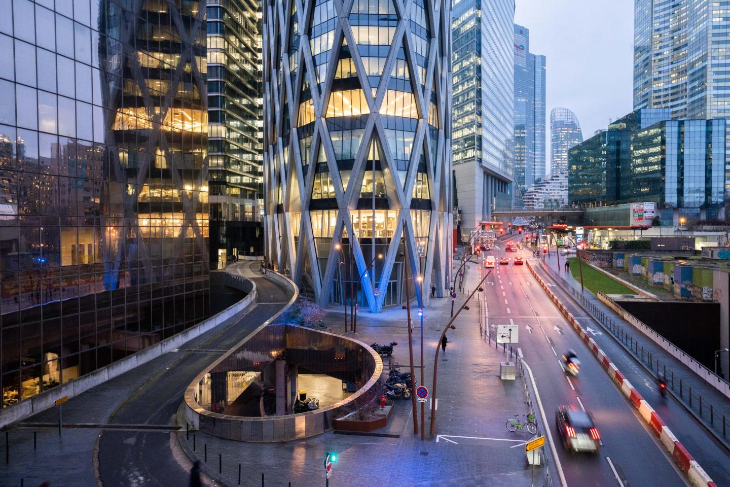 Illuminated office buildings in the early morning in La Defense business district of Paris, France.