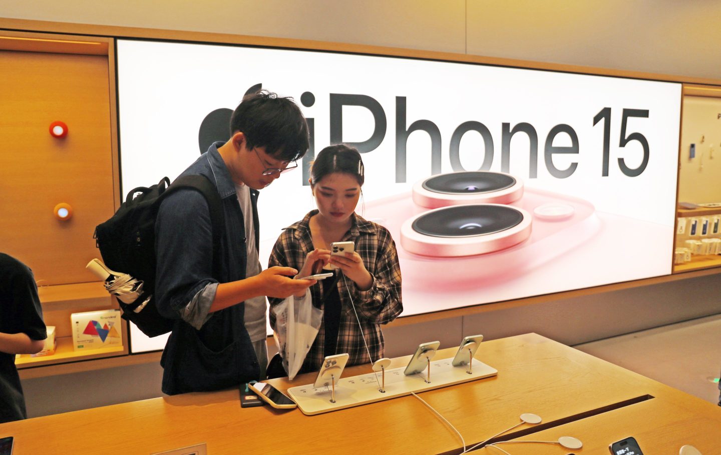 Customers experiencing the iPhone 15 at Apple's flagship store in Shanghai on Sept. 24, 2023.