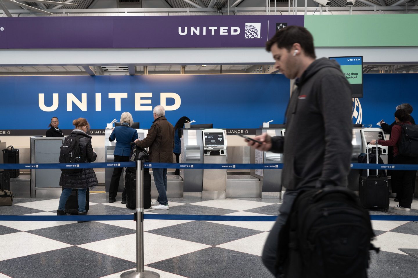 Passengers check in for United Airlines flights at O'Hare International Airport on January 23, 2024 in Chicago.