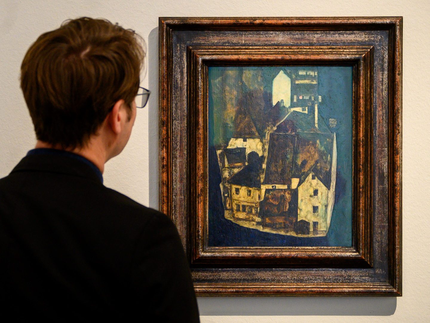 A visitor to the Leopold Museum in Vienna looks at a painting by Austrian expressionist painter Egon Schiele on Feb. 2. The recent restitution of several Nazi-plundered works by Austrian painter Egon Schiele to the heirs of the Jewish owner, has shone a spotlight on Austria's most prestigious museum collections. The descendants of Fritz Gruenbaum, an Austrian Jewish cabaret performer killed in the Holocaust, are pursuing 12 Schiele pieces housed in Viennese museums.