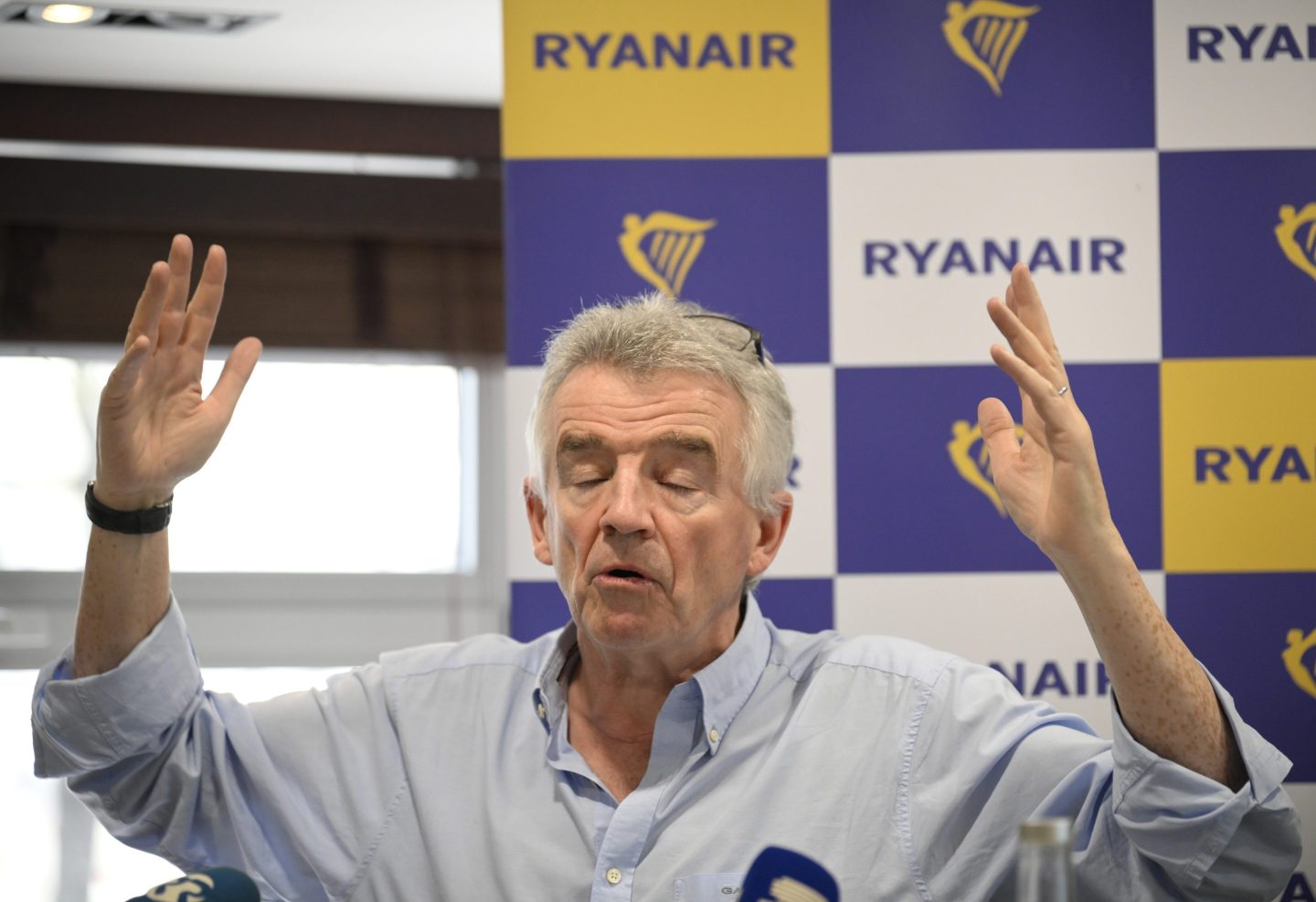 ryanair ceo Michael O'Leary with his hands up in the air