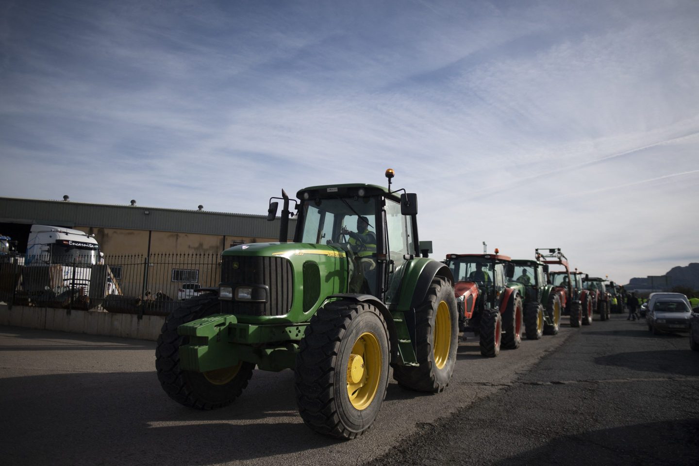 Protestors drive tractors during a farmers demonstration
