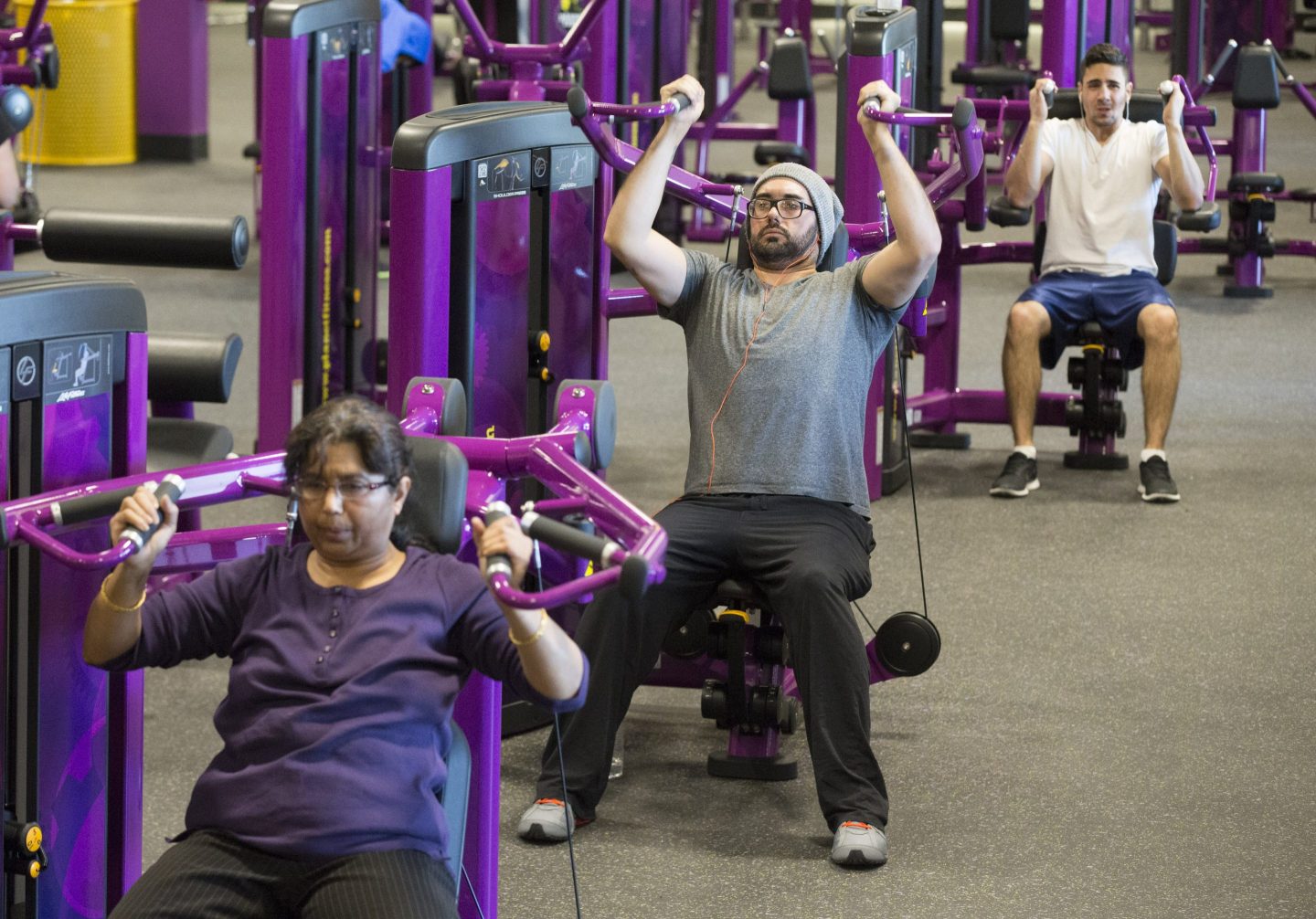 Fitness enthusiasts work out at Planet Fitness