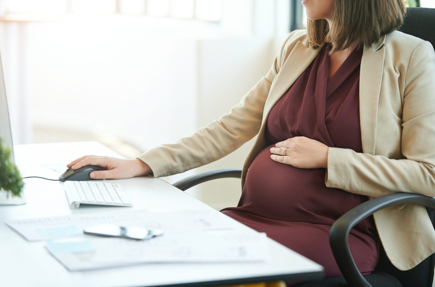 Cropped shot of a pregnant businesswoman working at her desk