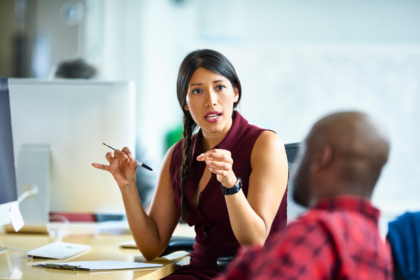Woman leader talks to employee.