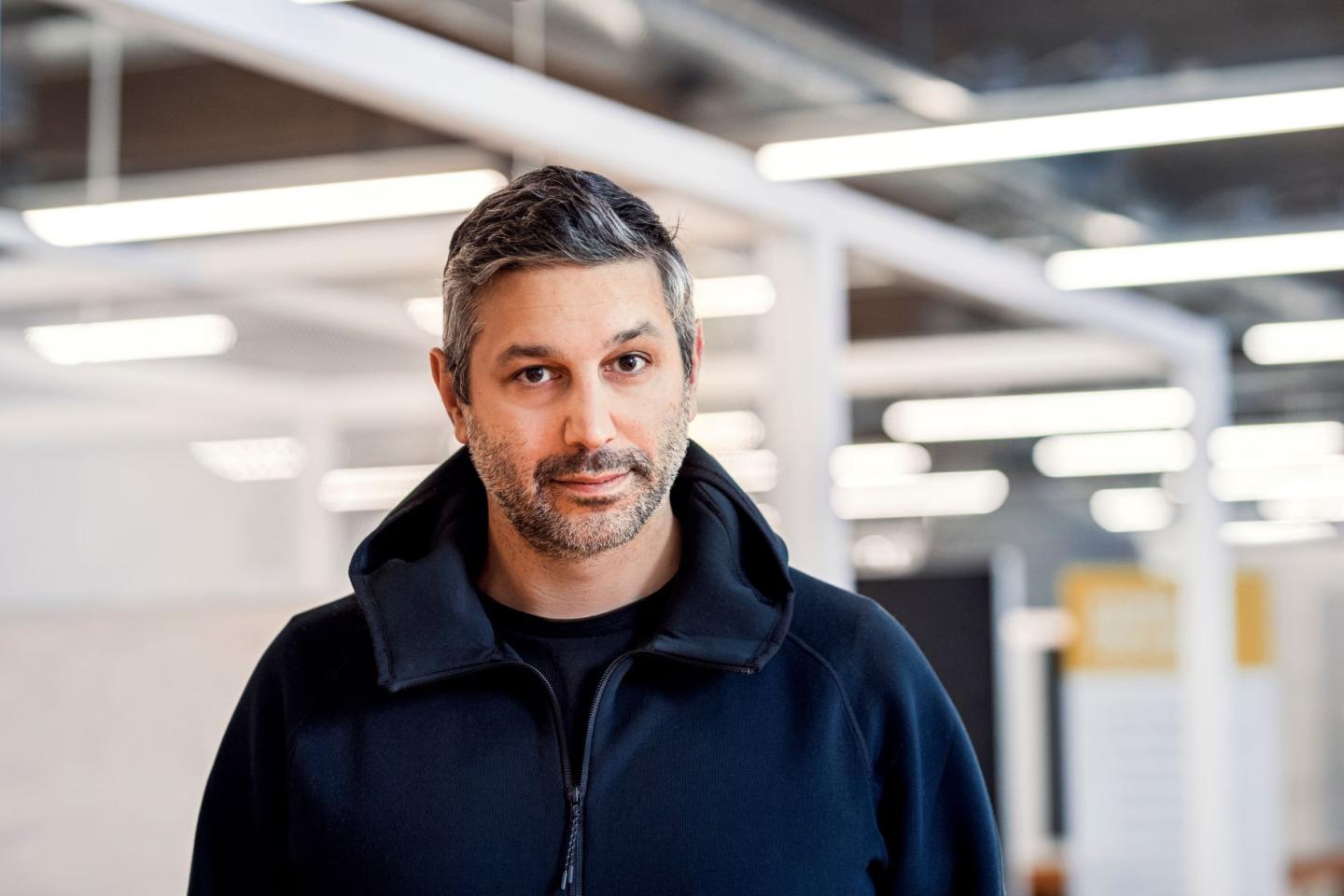 Tolga Oncu standing with lights behind him