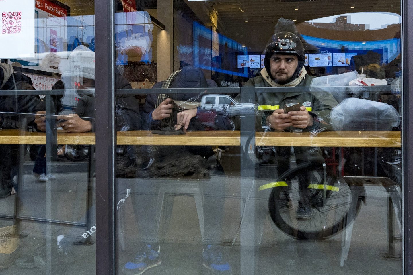 A delivery worker waits inside a Chick-fil-A restaurant on Feb. 1, 2024, in New York.