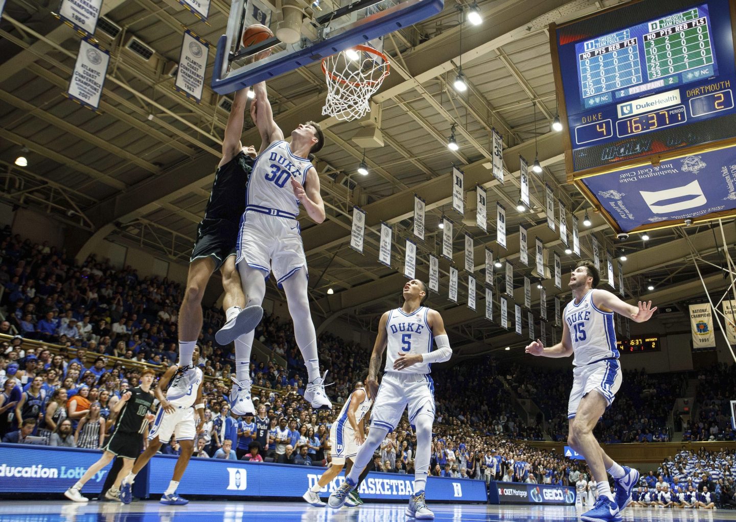 Duke's Kyle Filipowski (30) blocks the shot of Dartmouth's Dusan Neskovic, left, ahead of Duke's Tyrese Proctor (5) and Ryan Young (15) during the first half of an NCAA college basketball game in Durham, N.C. on Nov. 6, 2023.