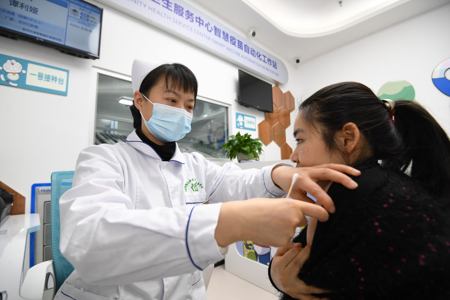 A medical worker vaccinating a patient