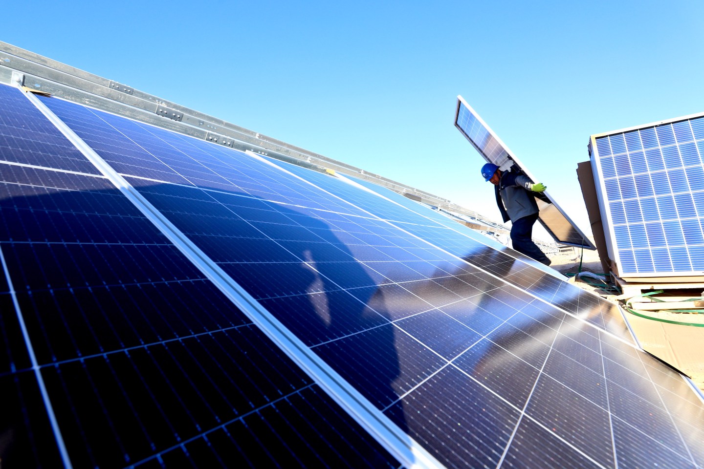 A worker installs solar panels