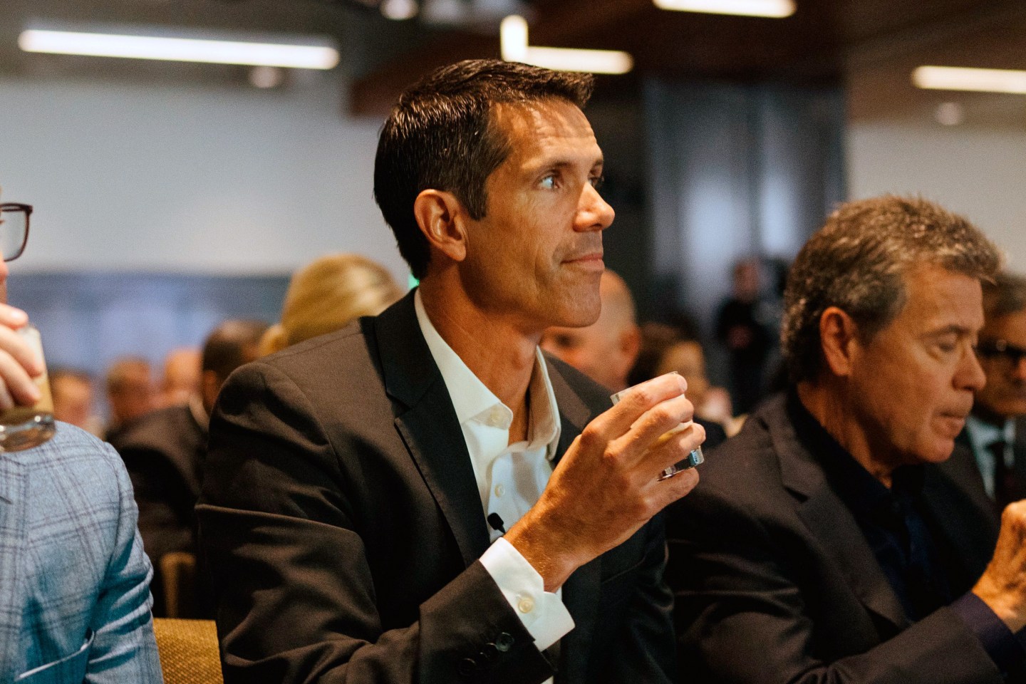 Brady Brewer sits between two executives at Starbucks investor day
