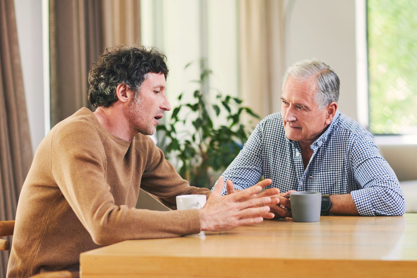 A father and his adult son conversing