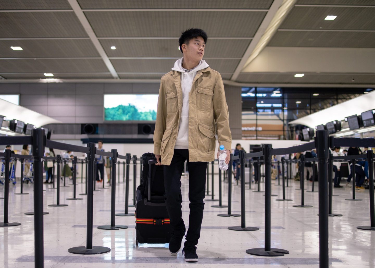 A young man walking through an airport