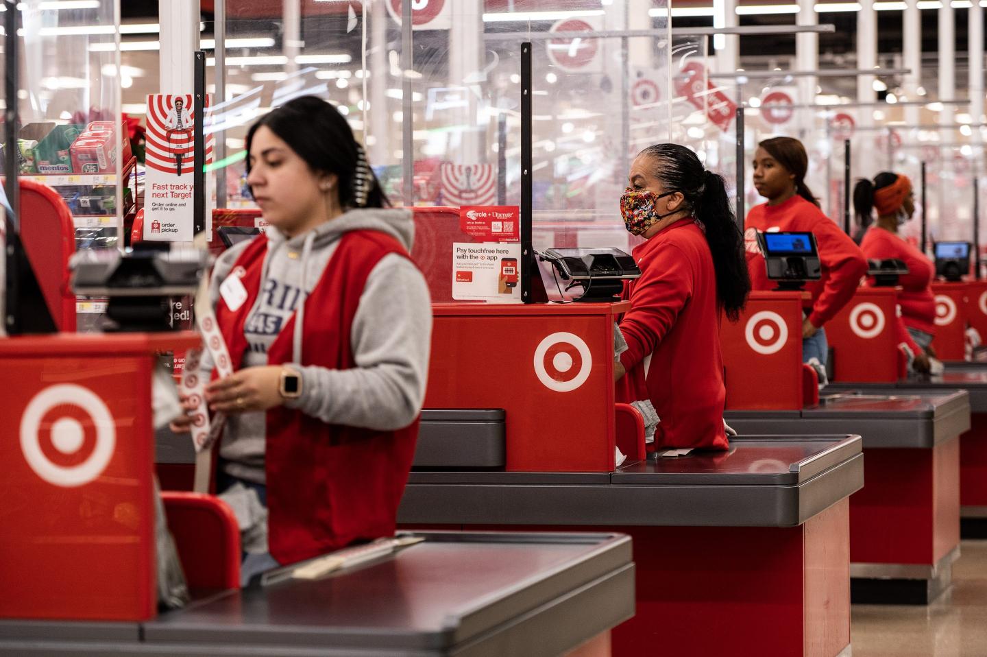 A line of Target cashiers are waiting at the checkout line to ring up customers.
