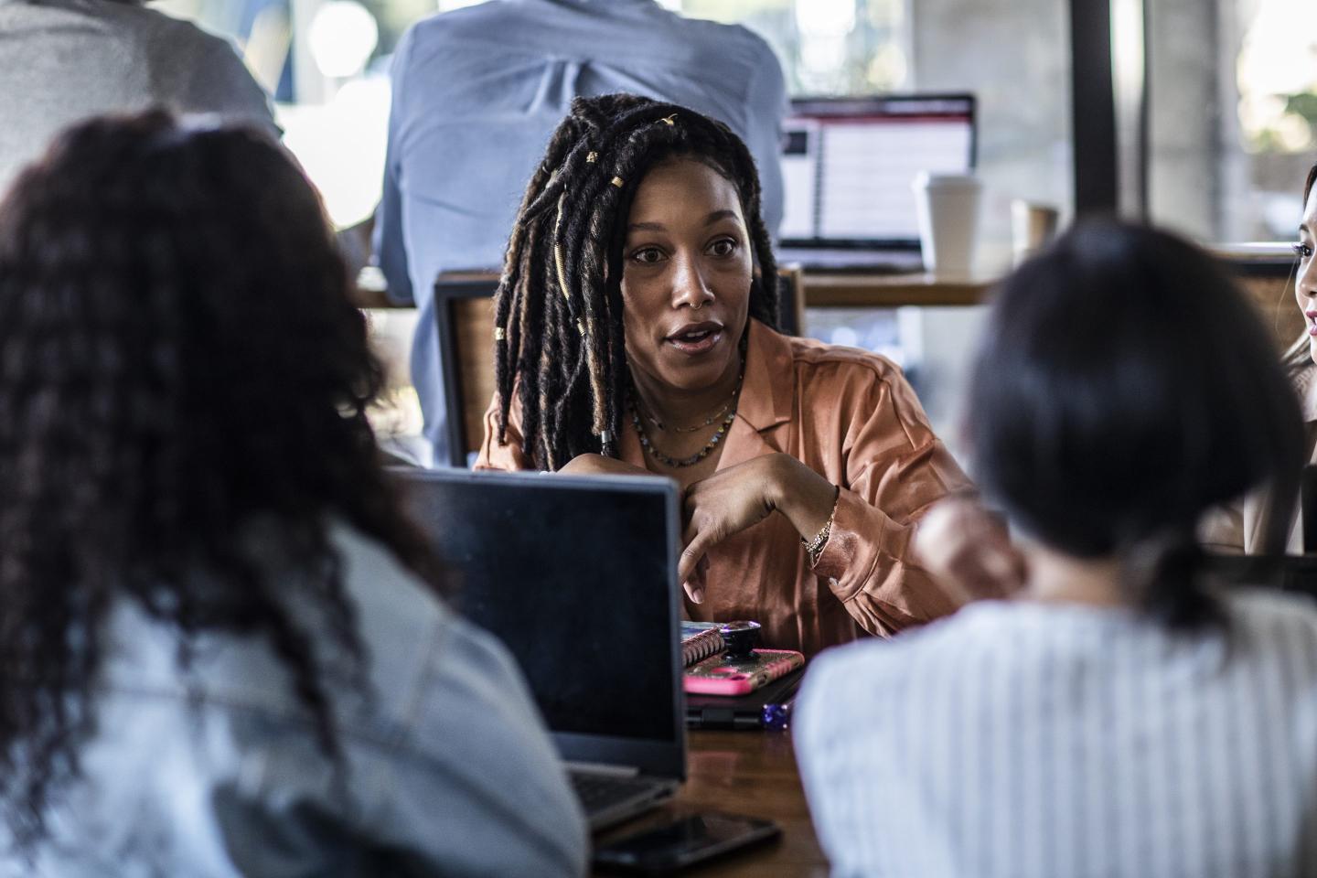 Young professional women collaborating in coffeeshop