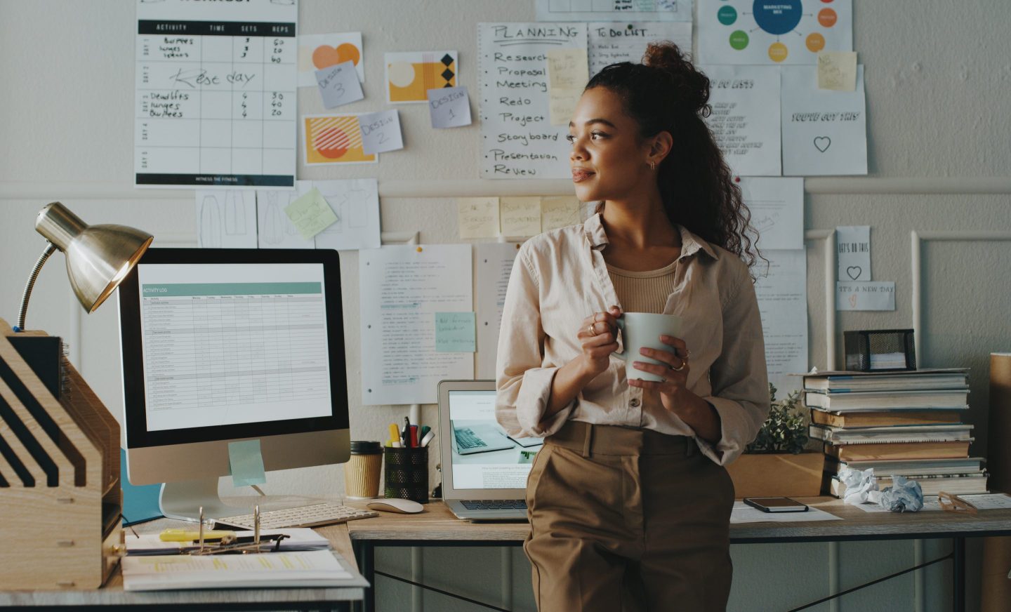 A young businesswoman stands in her office.
