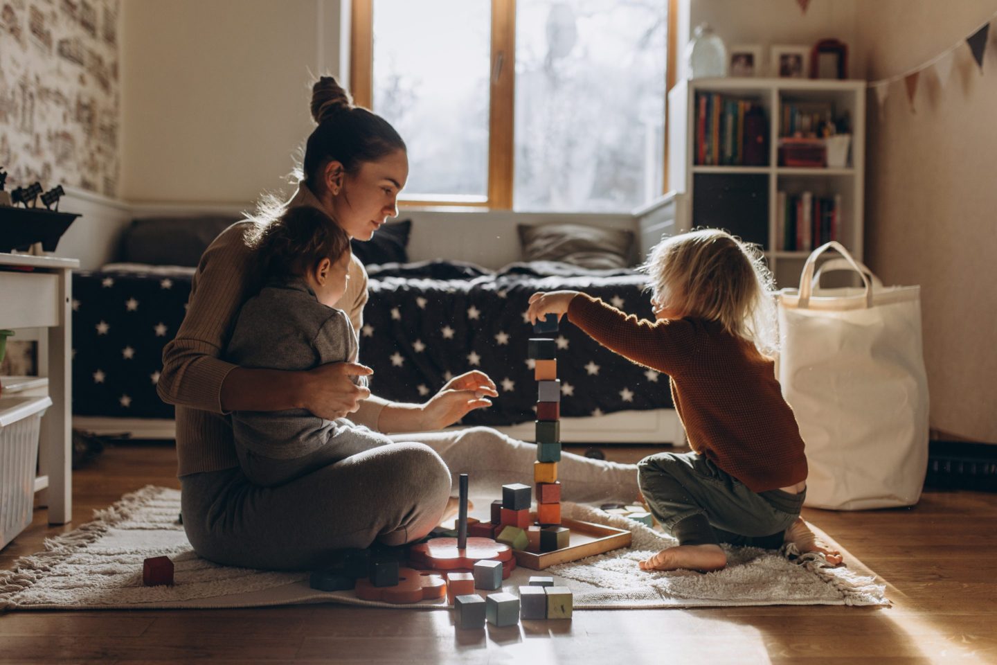 lady playing with two young kids