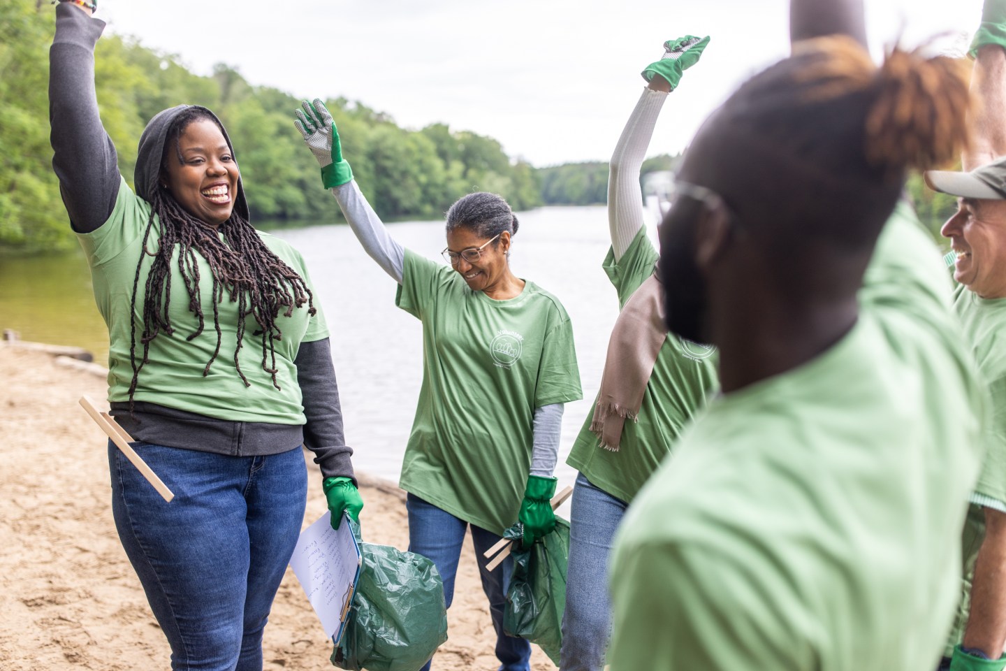 A group of company volunteers celebrate together.