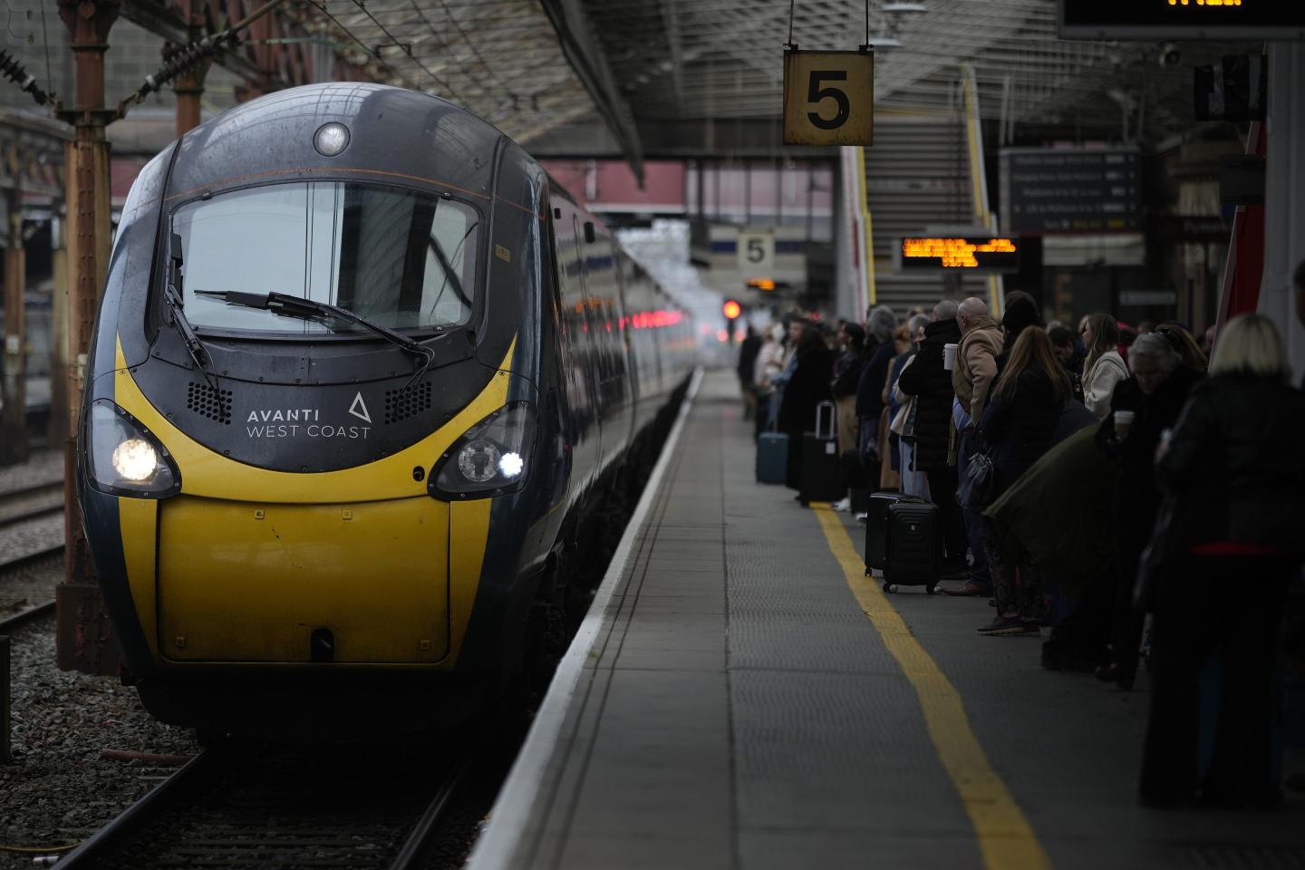 Passengers wait to board an Avanti West Coast mainline train at Crewe Station on December 01, 2022