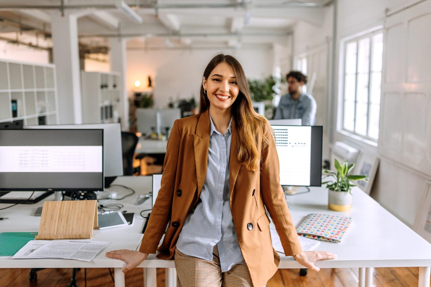 Young woman leaning on a desk
