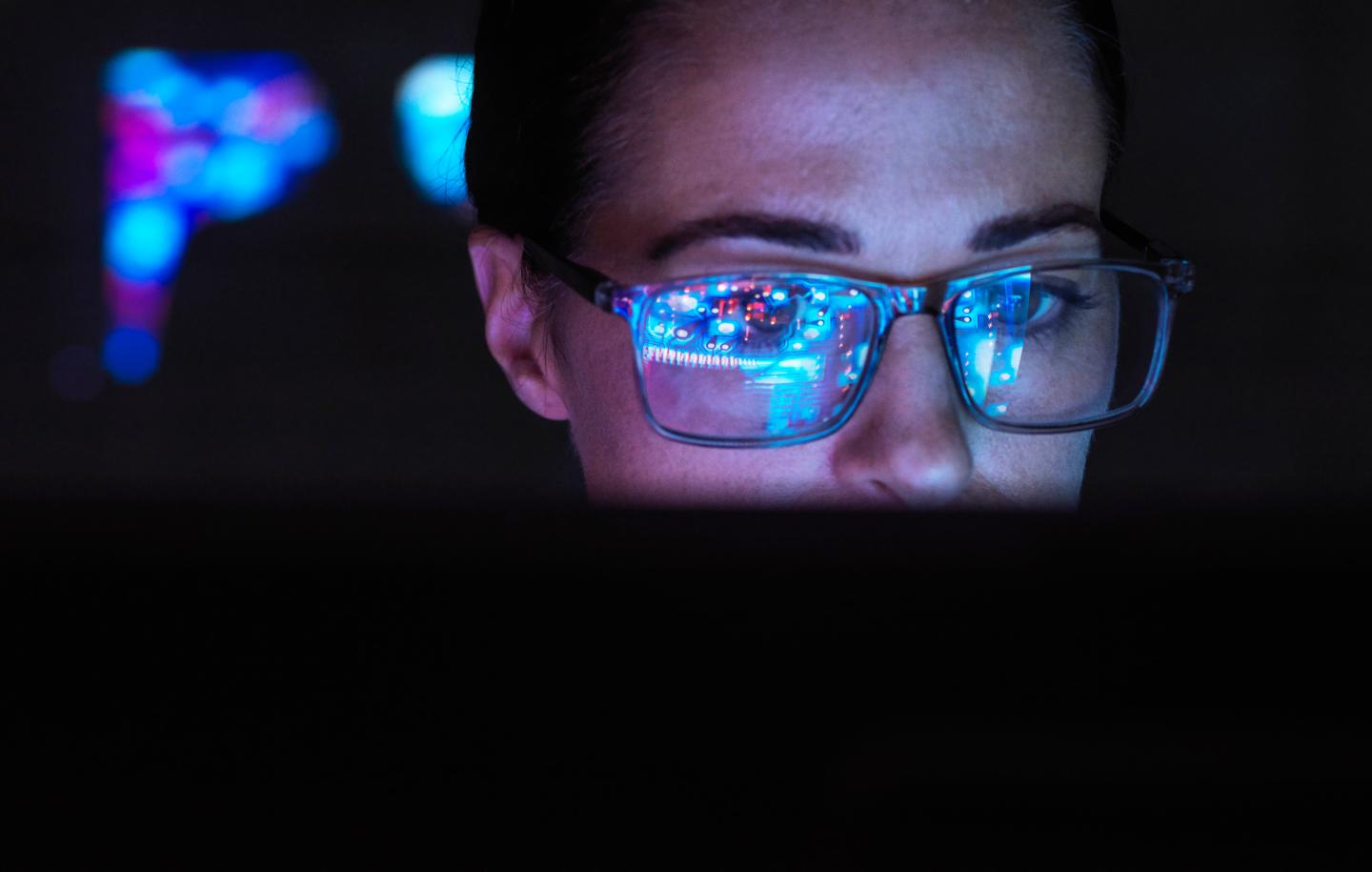 Worker uses AI on computer.